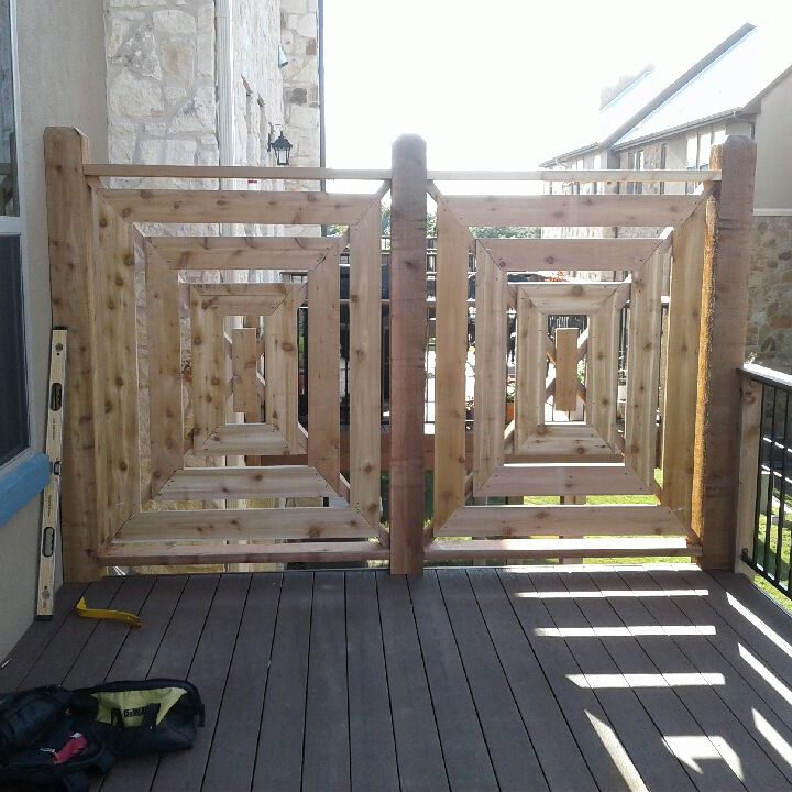 A wooden gate on the side of a house.