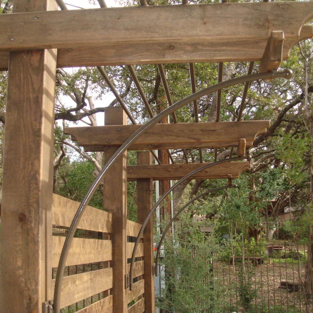 A wooden structure with a fence and trees in the background.