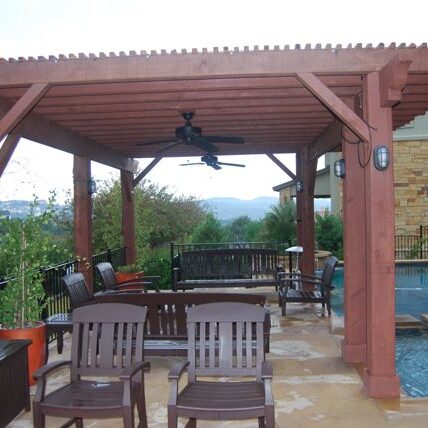 A patio with chairs and an outdoor fireplace.